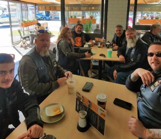 Gasoline Alley Chapter members around a café table