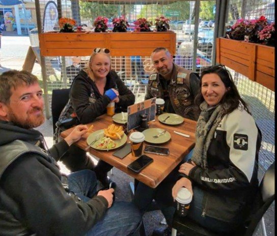 Chapter riders and pillions at a café table