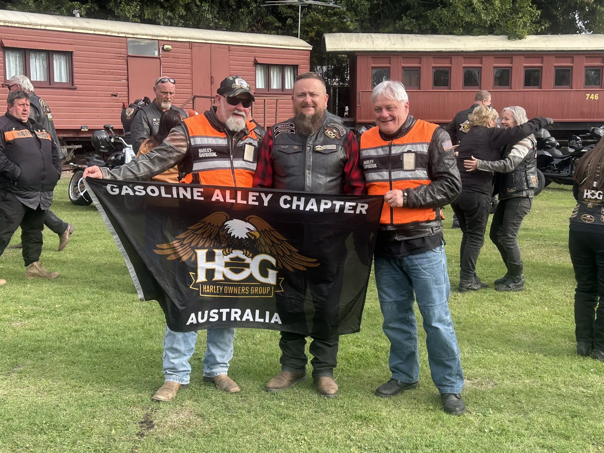 Gasoline Alley H.O.G. Chapter members holding the chapter banner at Harrisville
