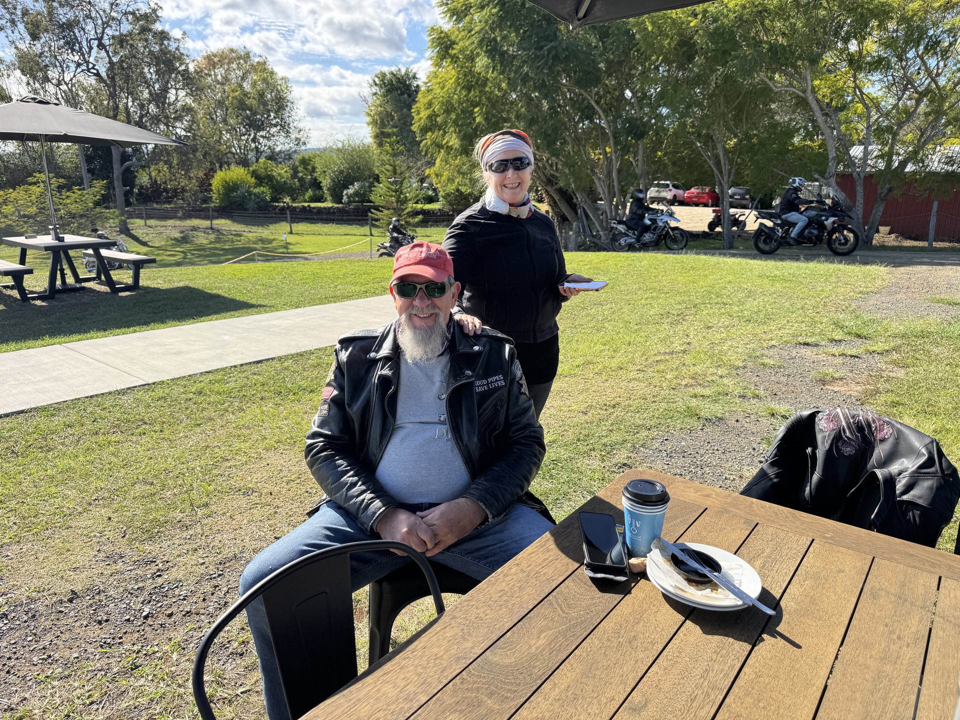 Two chapter members relaxing at a picnic table at Oaky Creek Farm