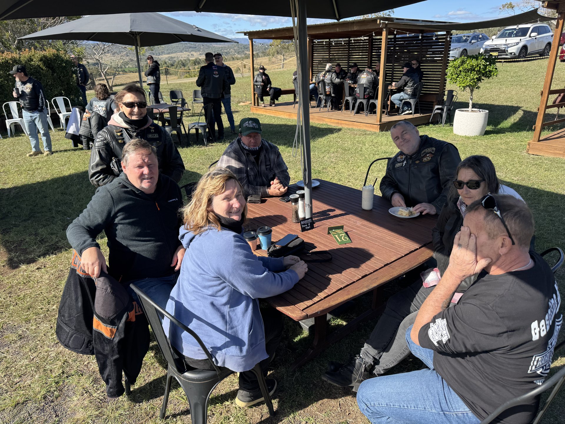 Chapter members seated outdoors at Oaky Creek Farm during the ride