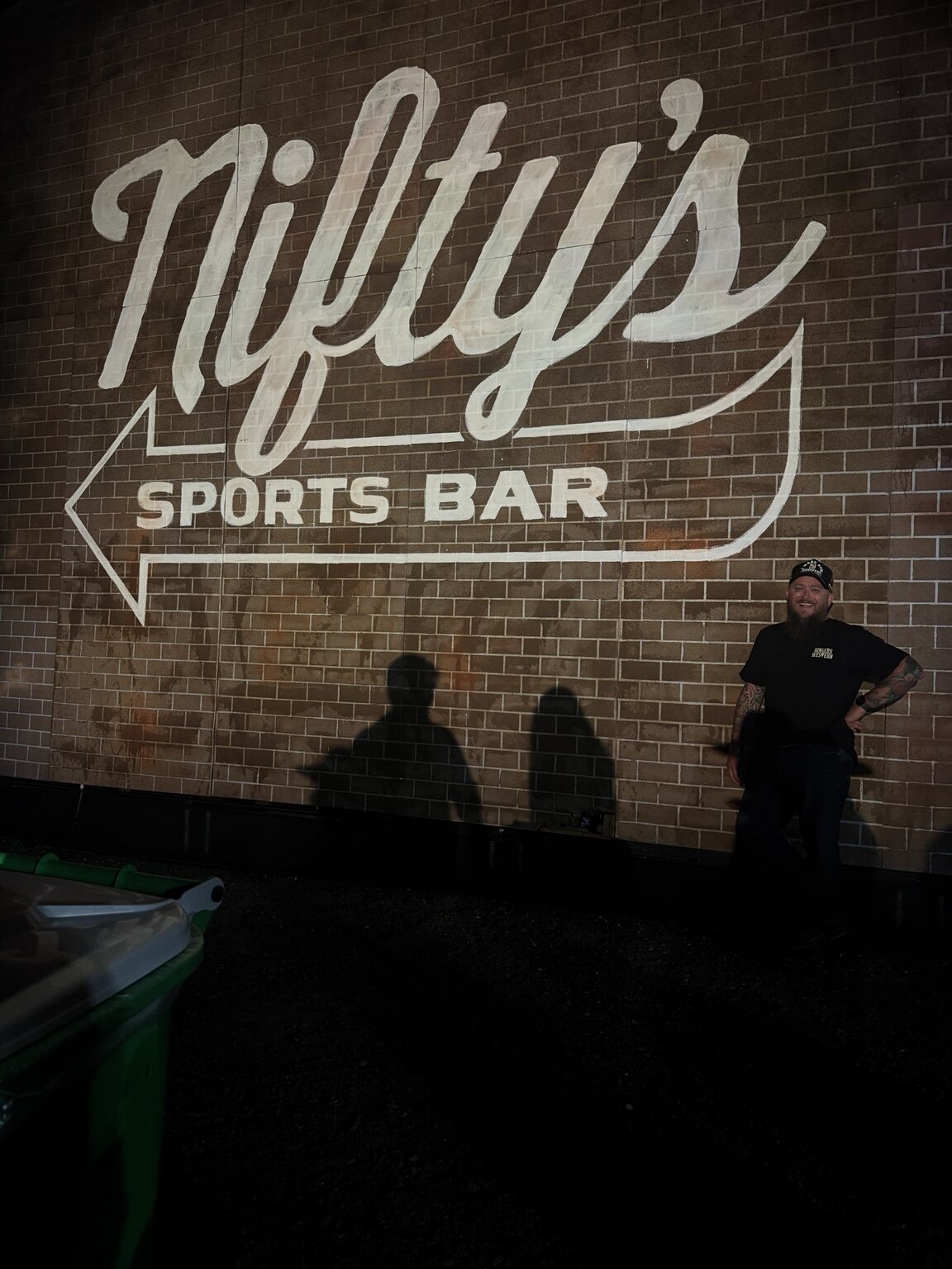 Shane standing near the Nifty's Sports Bar mural