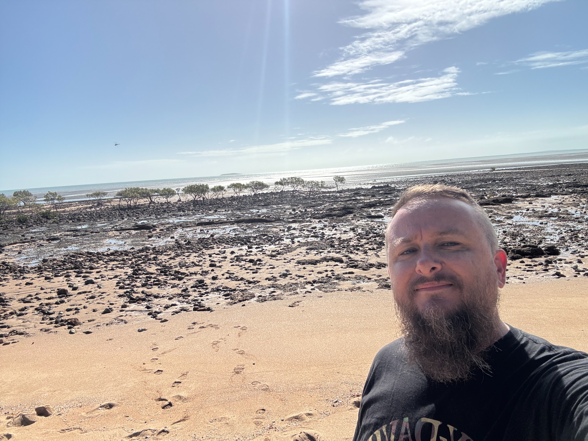 Selfie beside the rocky shoreline during the return trip.