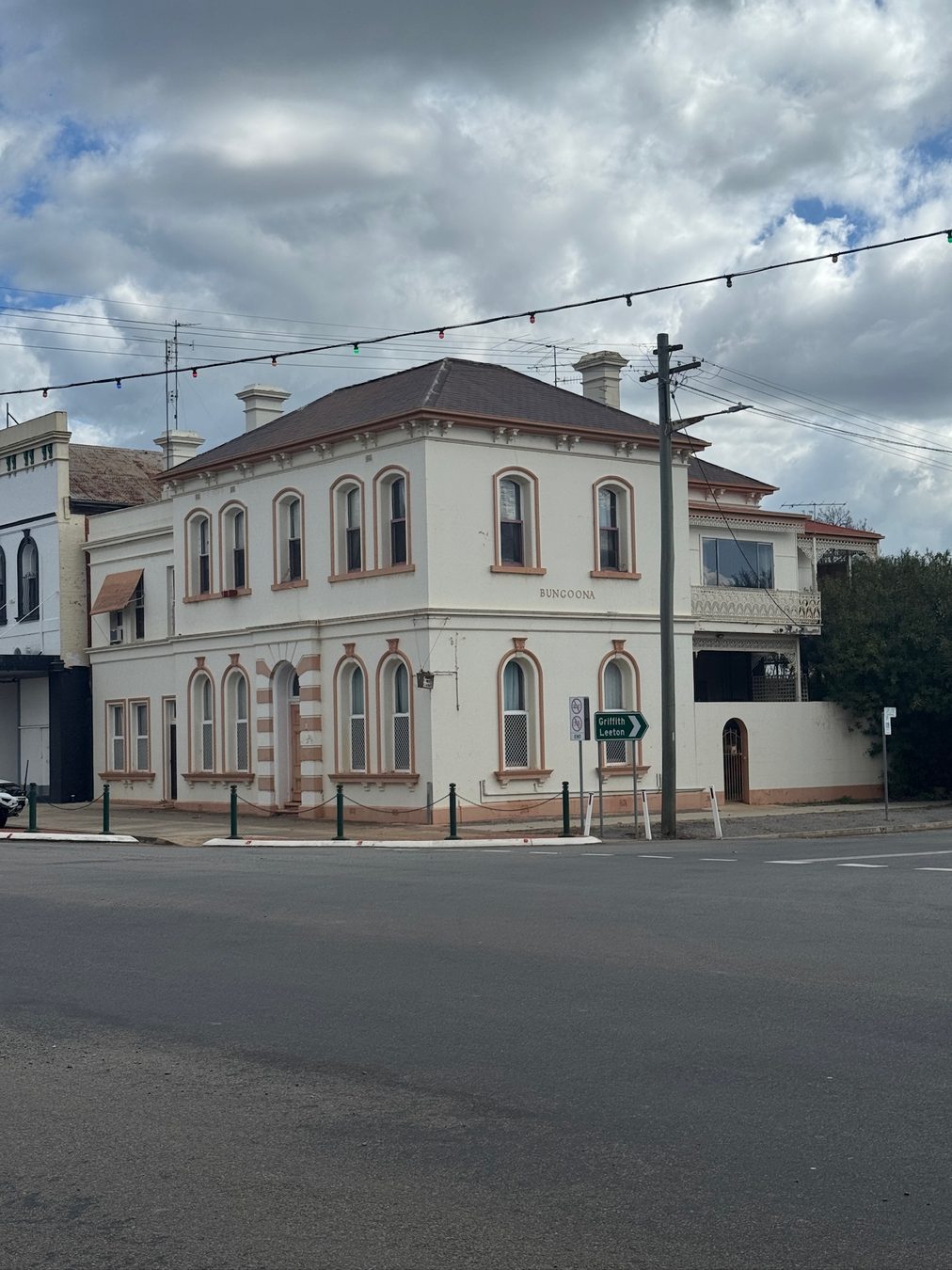 A historic corner building in Narrandera under a cloudy sky.
