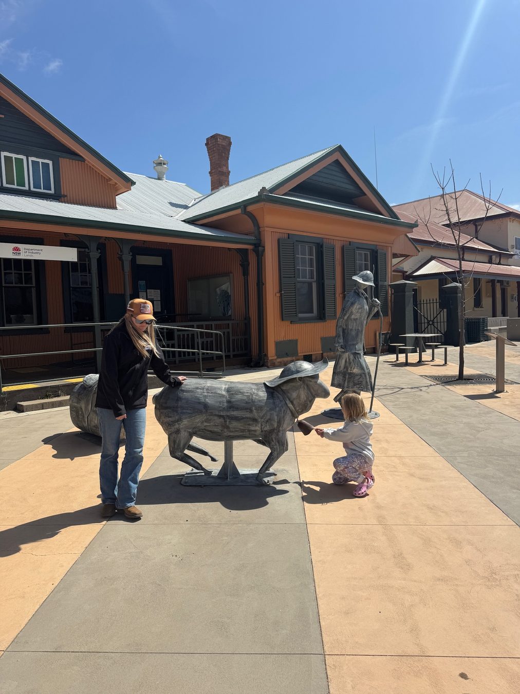 Family members posing with animal sculptures in Hay.