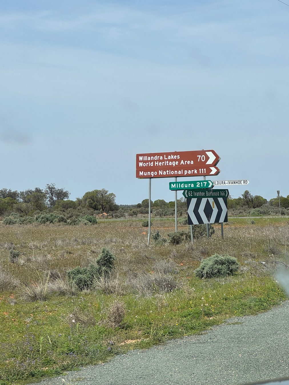 A roadside sign pointing towards Mungo National Park and nearby destinations.