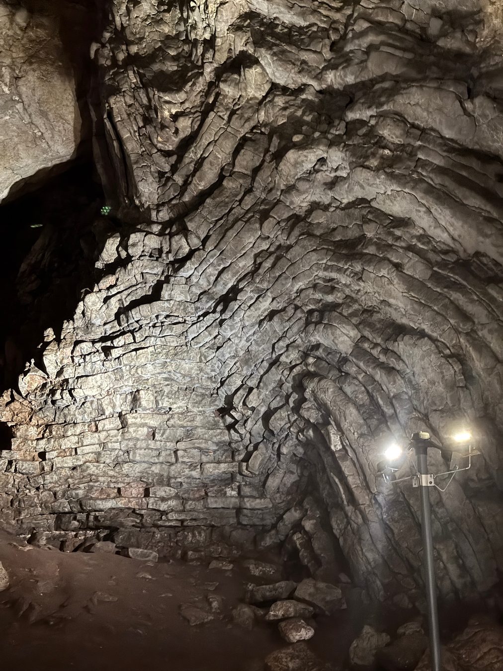 Layered limestone patterns across the cave ceiling.