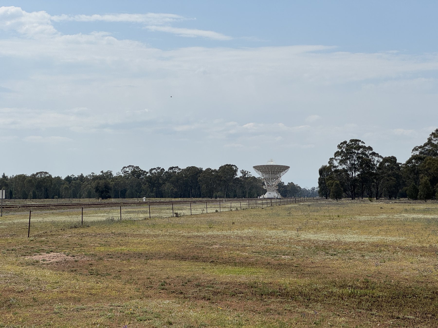 A radio telescope dish in the open landscape.