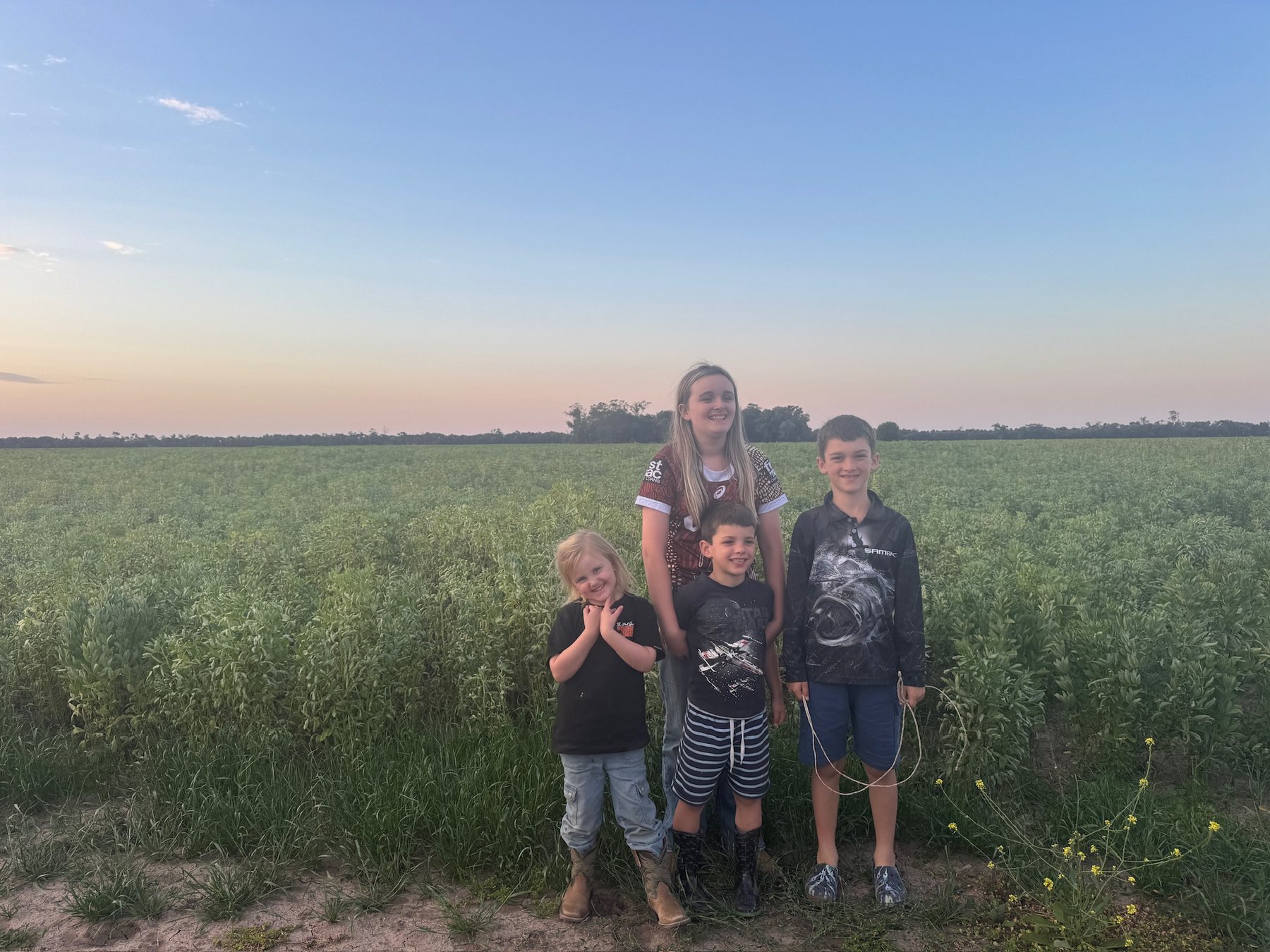 Family group in a green field near the end of the road trip